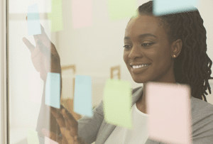 Home - black lady putting sticky notes on visualization b YRKSTMH